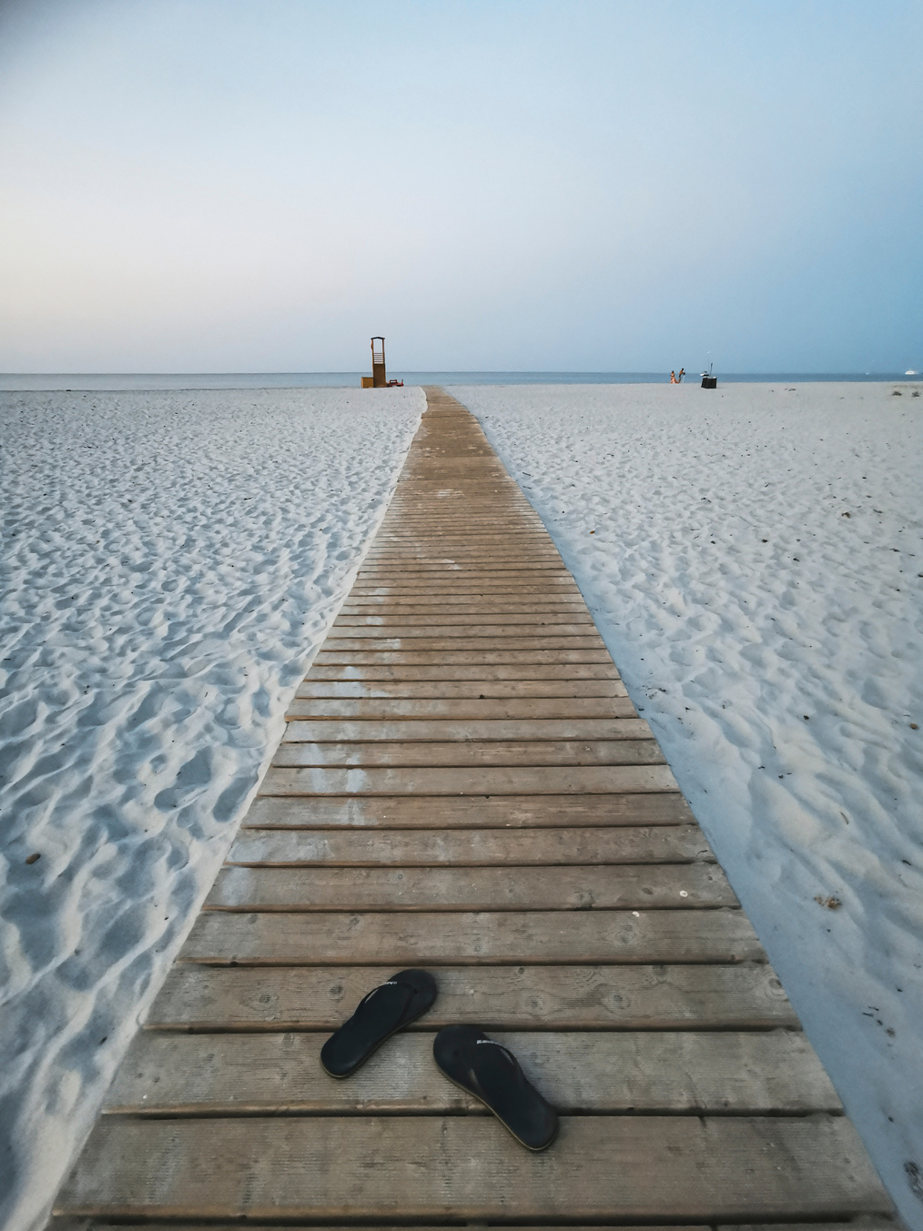 Slippers on Long Wooden Path on Sandy Beah